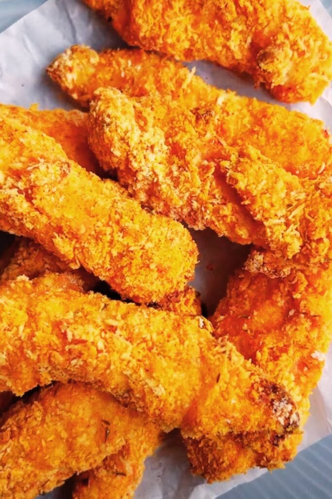 Various colorful dipping sauces arranged around golden chicken tenders